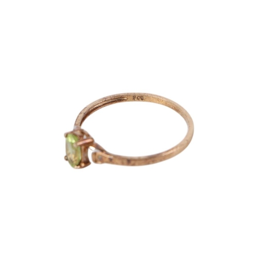 876 - A 9ct gold peridot dress ring, approx UK size M, 0.9g.