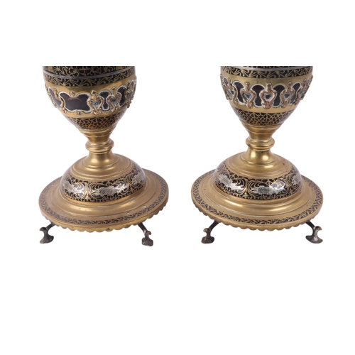 889 - A pair of North Indian Moradabad ware candle or lamp stands decorated with birds and fish, 41cms hig... 