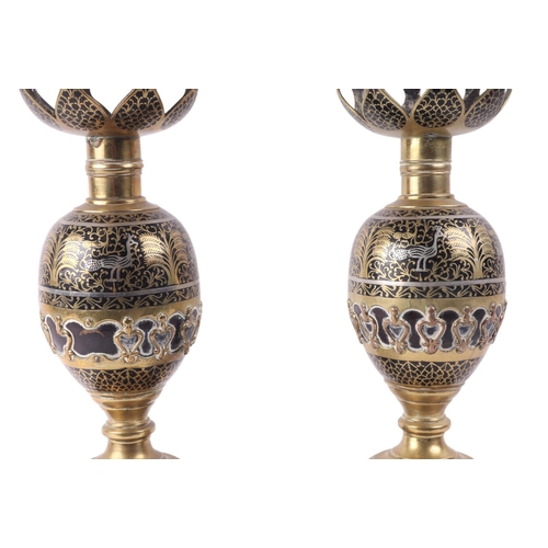 889 - A pair of North Indian Moradabad ware candle or lamp stands decorated with birds and fish, 41cms hig... 