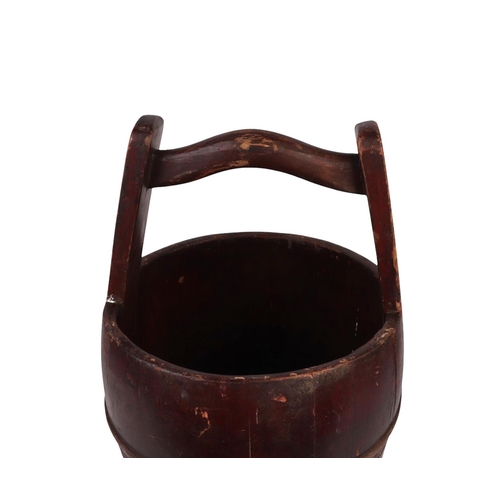 891 - An Oriental stained pine metal bound water bucket, 48cms high.