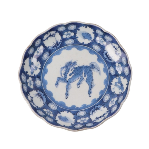 908 - A set of three Chinese blue & white porcelain plates decorated with qilin within a band of insects a... 