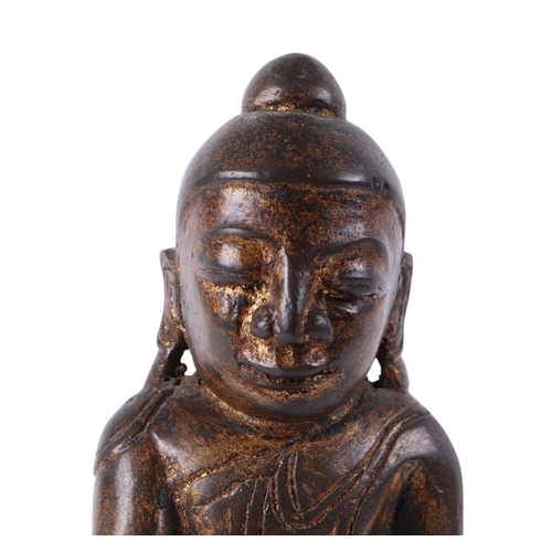 919 - A Burmese gilt bronze figure of a seated Buddha, 18cms high.