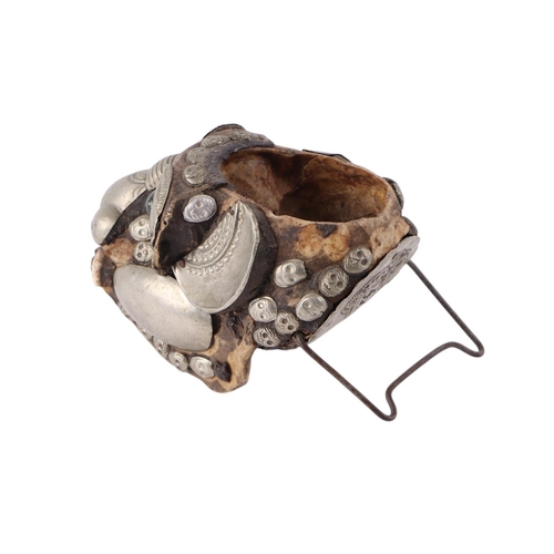 920 - A Tibetan metal mounted monkey skull cup, 15cms long.