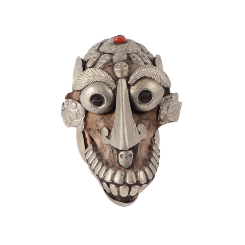 921 - A Tibetan metal mounted monkey skull, 15cms long.