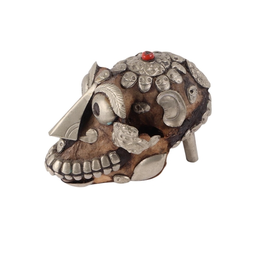 921 - A Tibetan metal mounted monkey skull, 15cms long.