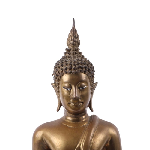 922 - A Thai bronze figure of a seated Buddha, 25cms high.