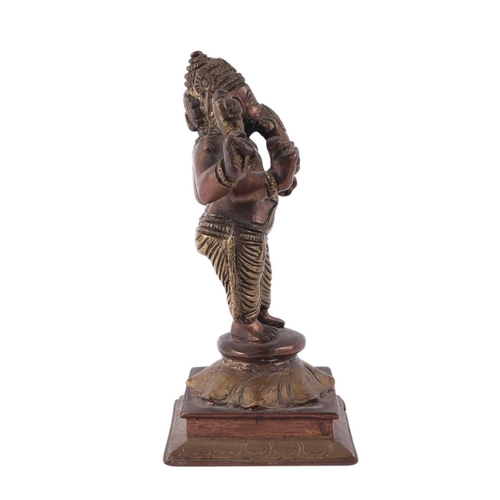 924 - An Indian brass and copper figure depicting Ganesh, 18cms high.