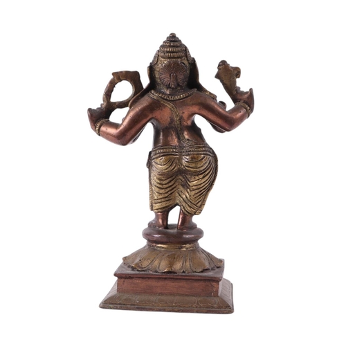 924 - An Indian brass and copper figure depicting Ganesh, 18cms high.