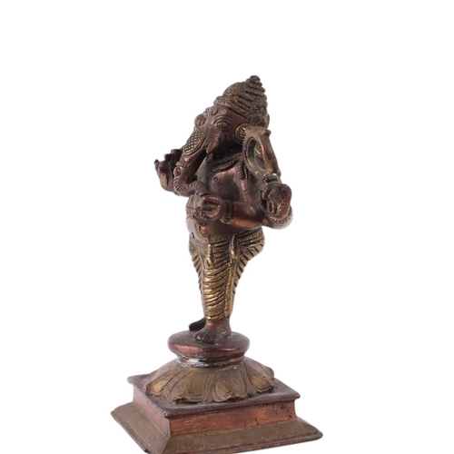 924 - An Indian brass and copper figure depicting Ganesh, 18cms high.