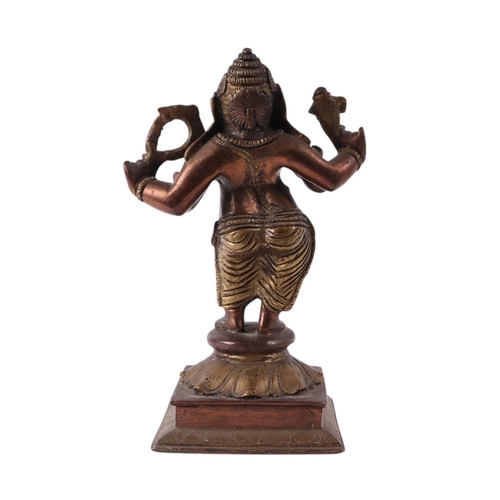 924 - An Indian brass and copper figure depicting Ganesh, 18cms high.