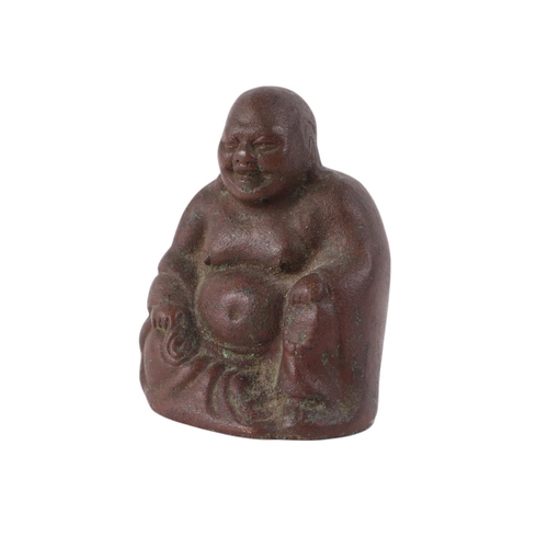 925 - A Chinese hollow cast figure of a seated Buddha, on a hardwood stand, 11cms high.