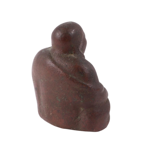 925 - A Chinese hollow cast figure of a seated Buddha, on a hardwood stand, 11cms high.