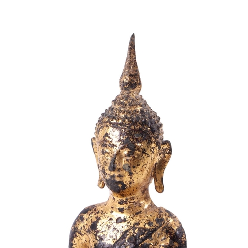 927 - A gilt bronze Thai figure of a seated Buddha on a raised stepped plinth, 16cms high.