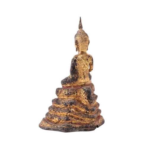 927 - A gilt bronze Thai figure of a seated Buddha on a raised stepped plinth, 16cms high.