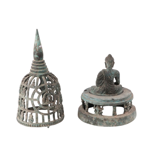 929 - An Indian Gandhara seated Buddha mounted on a stand and seated under a pierced cage, 45cms high.