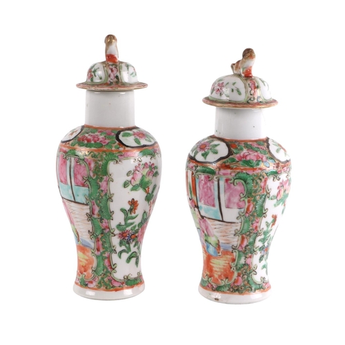 930 - A pair of Chinese Canton Export famille rose lidded vases decorated with figures, four character blu... 