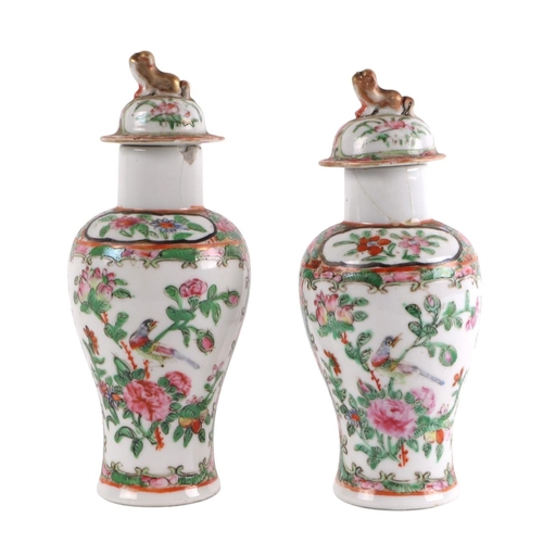 930 - A pair of Chinese Canton Export famille rose lidded vases decorated with figures, four character blu... 