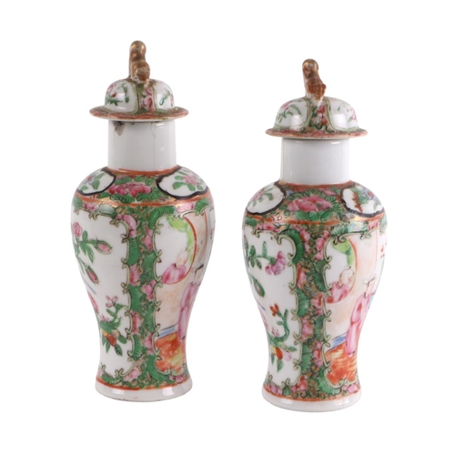 930 - A pair of Chinese Canton Export famille rose lidded vases decorated with figures, four character blu... 