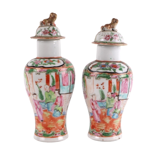 930 - A pair of Chinese Canton Export famille rose lidded vases decorated with figures, four character blu... 