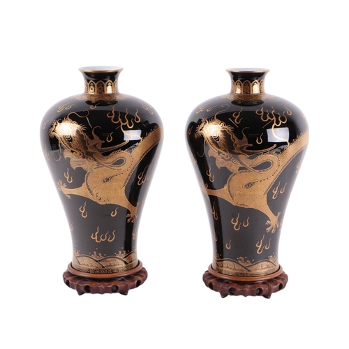 931 - A pair of Chinese famille noir Meiping type vases decorated with gilded dragons chasing a flaming pe... 