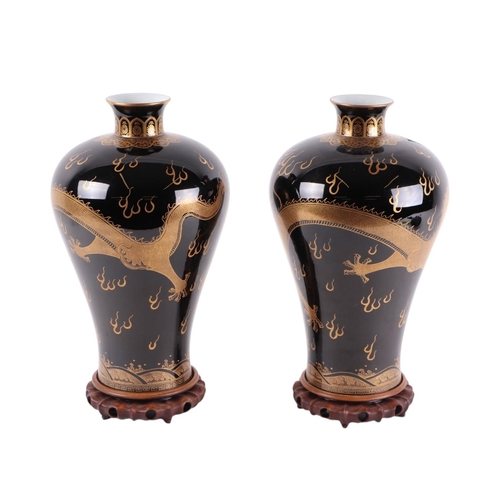 931 - A pair of Chinese famille noir Meiping type vases decorated with gilded dragons chasing a flaming pe... 