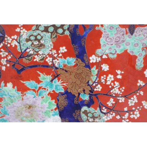 938 - A large Japanese charger decorated with a stylised prunus tree, four character blue mark to the unde... 