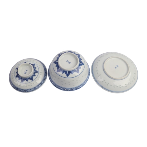 943 - A quantity of Chinese blue & white rice grain bowls, covers, side plates and spoons.