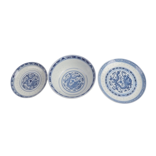 943 - A quantity of Chinese blue & white rice grain bowls, covers, side plates and spoons.