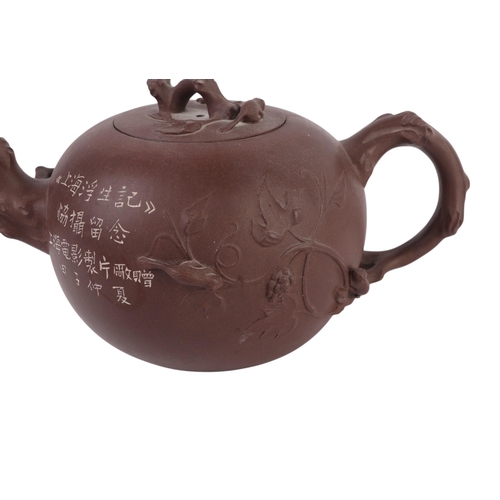 946 - A Chinese Yixing pottery teapot, 11cms high; together with two Chinese Yixing miniature teapots (3).