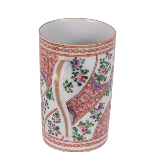 955 - A Chinese famille rose tankard, 15cms high.Condition ReportThere are two hairline cracks running dow... 