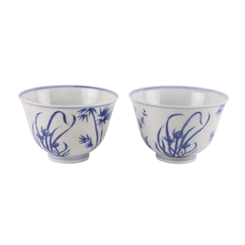 959 - A pair of Chinese blue & white footed bowls decorated with flowering foliage and bamboo with a drago... 