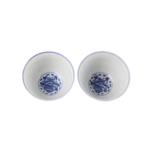 959 - A pair of Chinese blue & white footed bowls decorated with flowering foliage and bamboo with a drago... 