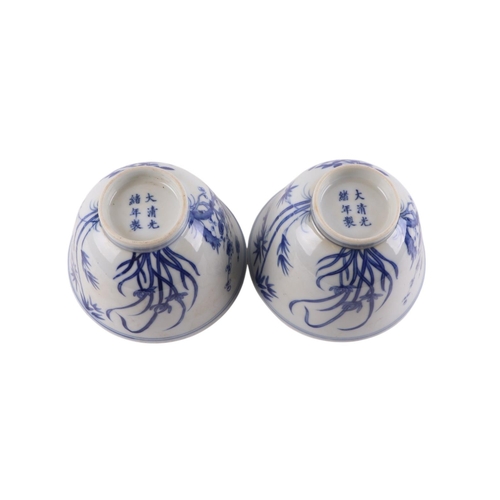 959 - A pair of Chinese blue & white footed bowls decorated with flowering foliage and bamboo with a drago... 