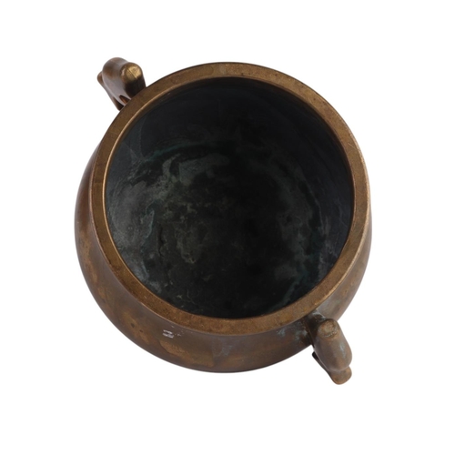 964 - A Chinese two-handled bronze censer with six character mark to the underside, 13cms diameter.