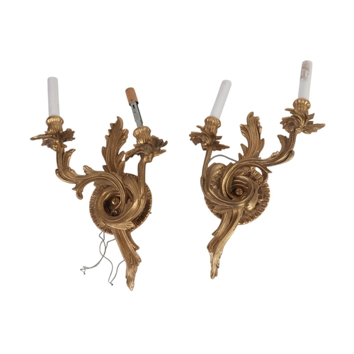 991 - A pair of rococo style twin-arm wall lights, 37cms high (2).