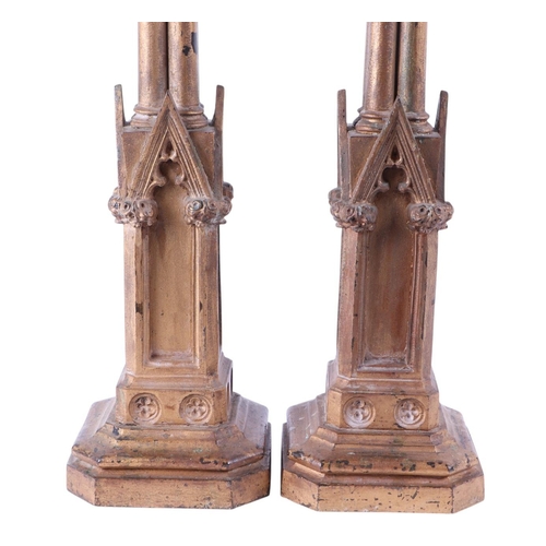 994 - A pair of gilt bronze / brass Gothic style candlesticks in the Pugin manner, converted to table lamp... 