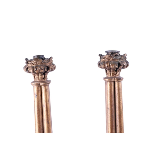 994 - A pair of gilt bronze / brass Gothic style candlesticks in the Pugin manner, converted to table lamp... 