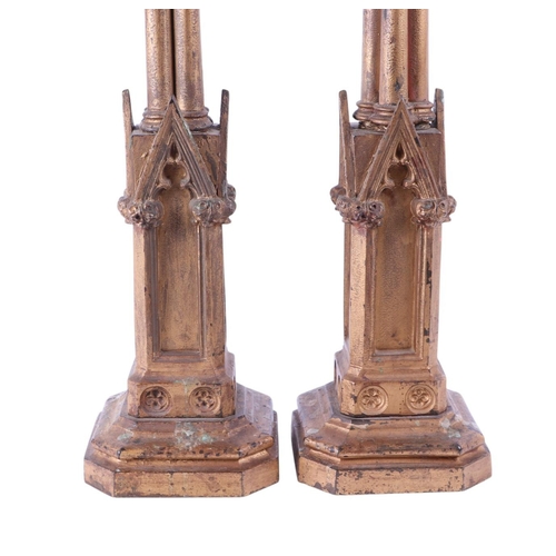 995 - A pair of gilt bronze / brass Gothic style candlesticks in the Pugin manner, converted to table lamp... 