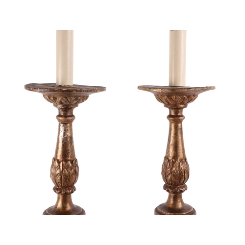 997 - A pair of ornate giltwood lamps on three paw feet (later converted to electricity), 64cms high exclu... 