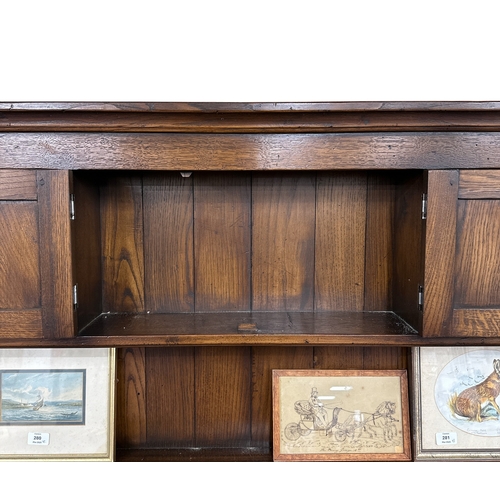 1137 - An 18th century style oak dresser, 183cms wide.