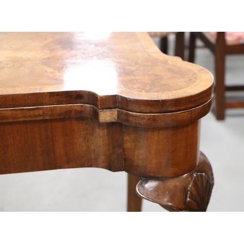 1107 - A 19th century Queen Anne style walnut concertina action card table, the quarter veneered top with c... 