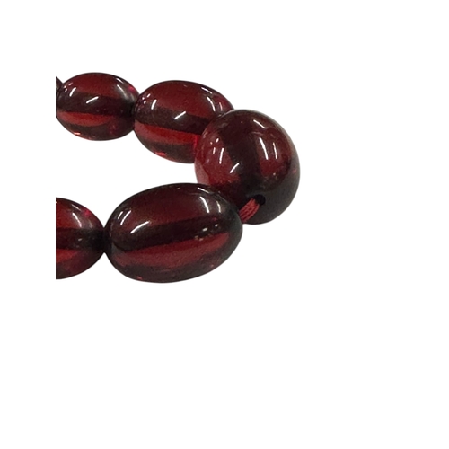 798 - A cherry amber Bakelite style graduated bead necklace,43g, 61cms long.