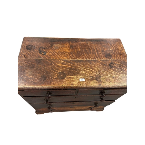 1097 - A late 18th / early 19th century oak country chest of two short and three graduated long drawers, on... 