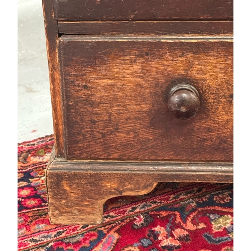 1097 - A late 18th / early 19th century oak country chest of two short and three graduated long drawers, on... 