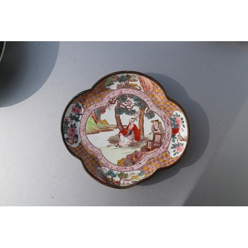 940 - A Chinese enamel shaped dish decorated with figures in a landscape, 12cms wide; together with a Chin... 