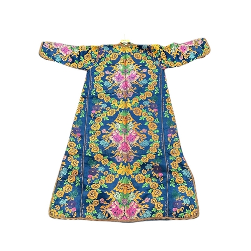 163 - A Moroccan embroidered kaftan decorated with flowers on a blue ground, signed.