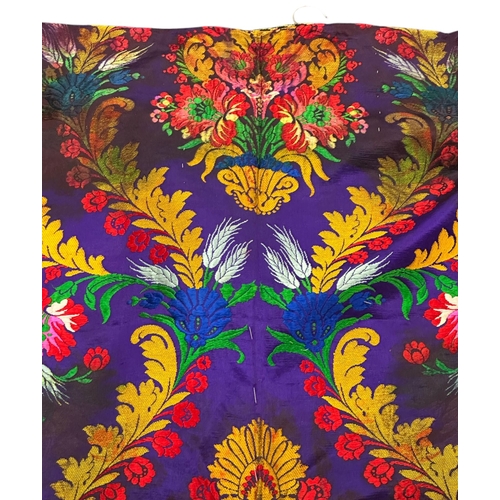 165 - A Moroccan embroidered kaftan decorated with flowers on a purple ground.