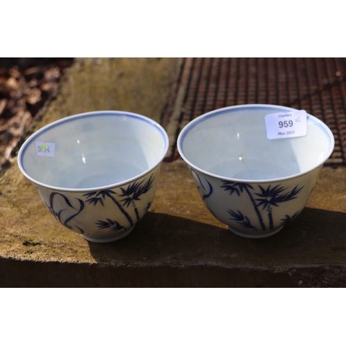 959 - A pair of Chinese blue & white footed bowls decorated with flowering foliage and bamboo with a drago... 