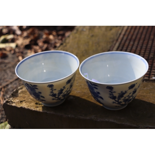 959 - A pair of Chinese blue & white footed bowls decorated with flowering foliage and bamboo with a drago... 