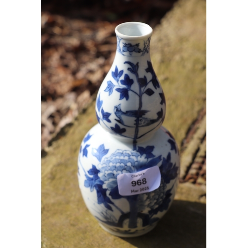 968 - A Chinese blue & white double gourd vase decorated with a bird amongst flowering foliage, four chara... 